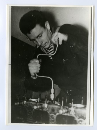 Лейман Вениямин курсант ПШМ  регулирует клапаны двигателя. 1960 г